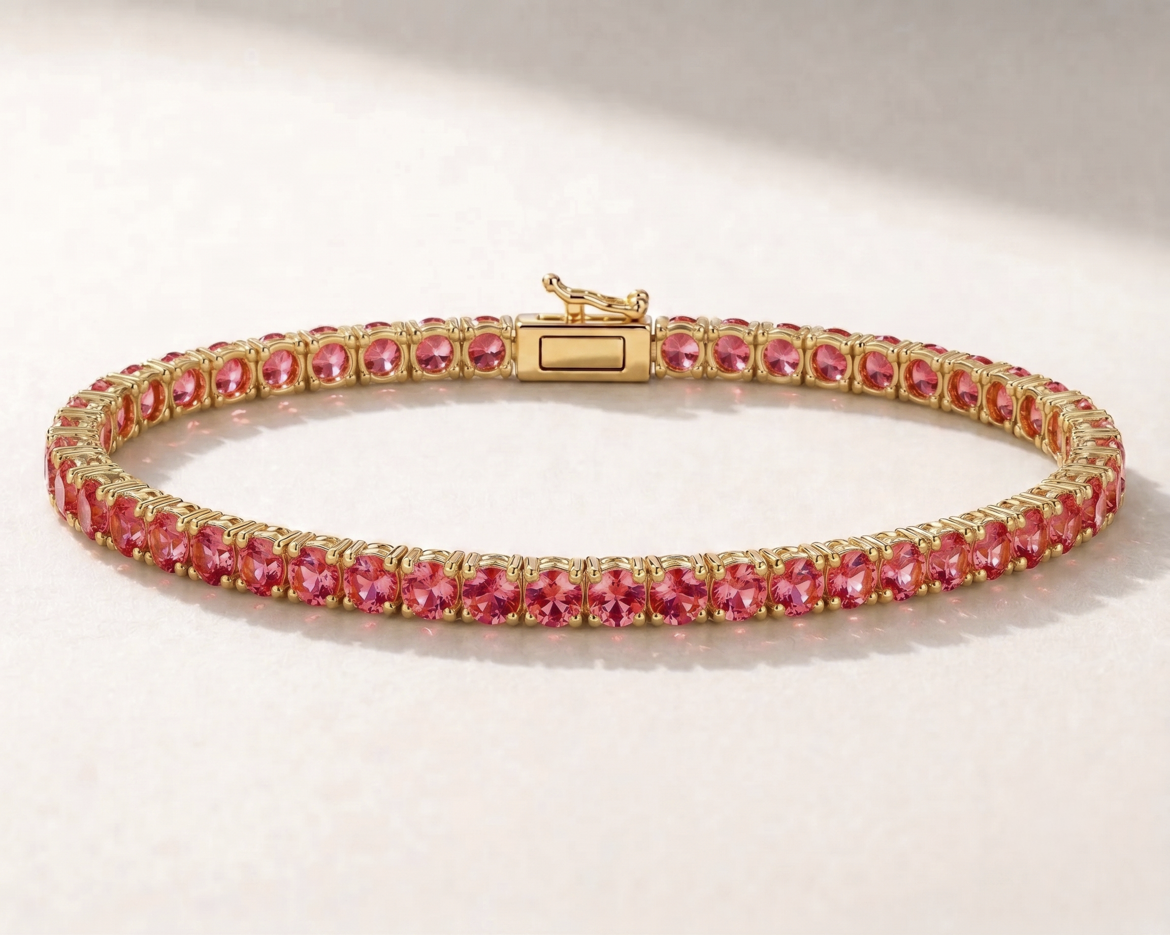 14K gold lab sapphire tennis bracelet in Padparadscha