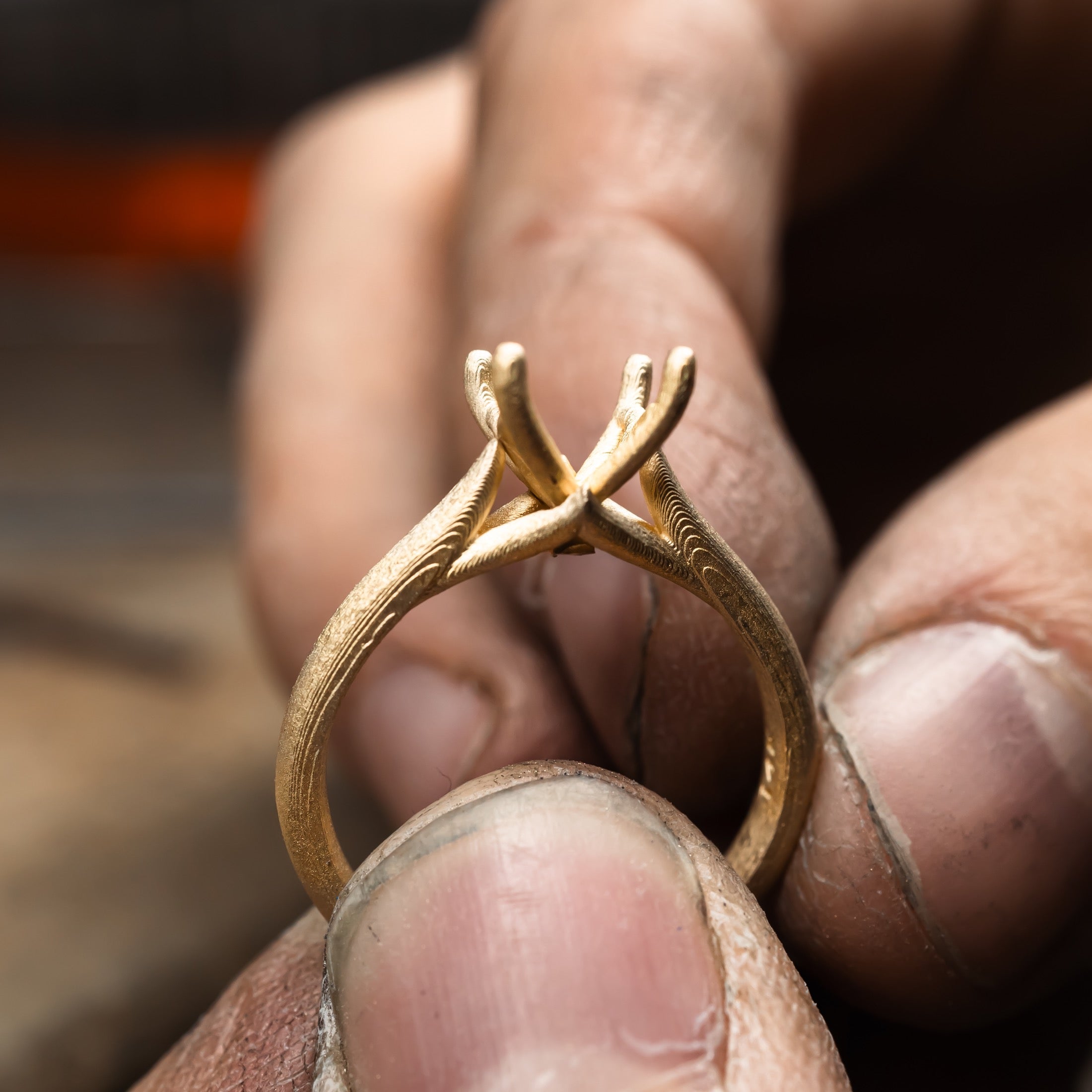 Atelier RMR jeweller holding a custom gold ring during the jewellery making process in Montreal