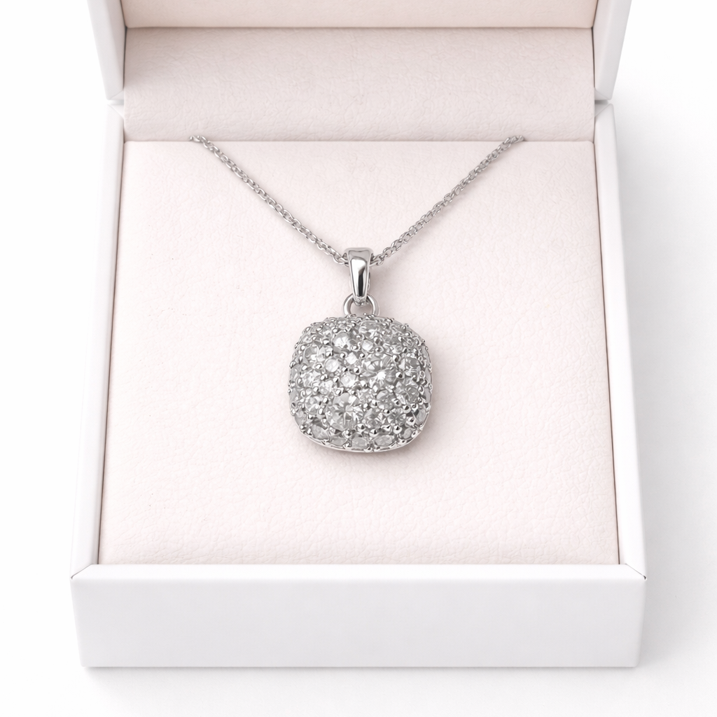 White gold necklace with a round pendant in an open white box on a white background