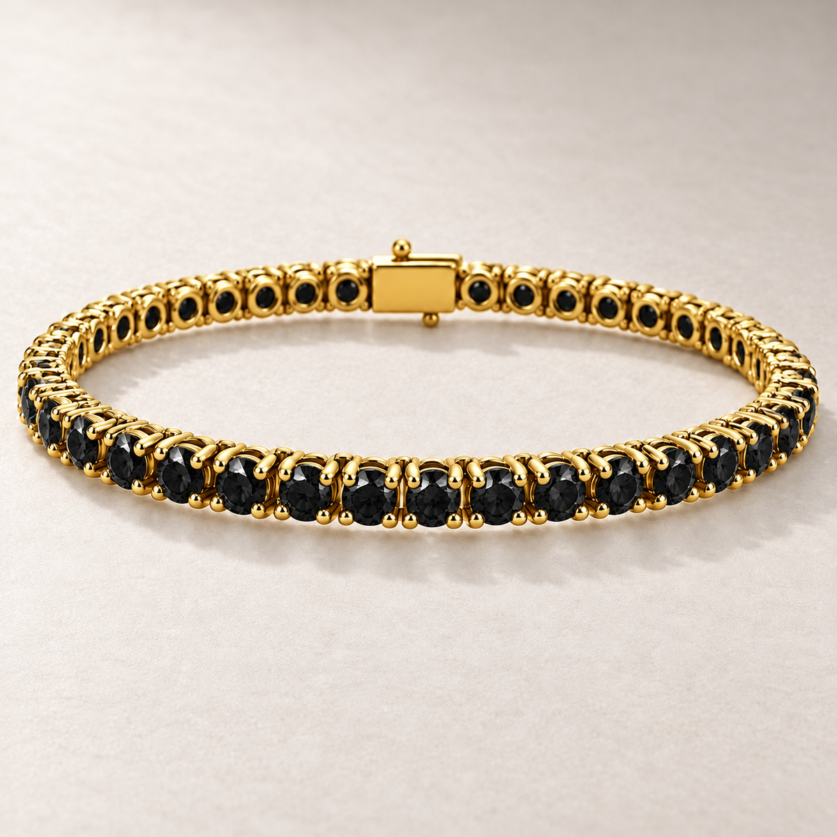 Bracelet TN08 en or jaune, diamants noirs, fond pierre greige — TN08 yellow gold bracelet with black diamonds on greige stone.
