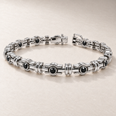 Bracelet TN18 en or blanc, diamants noirs, fond pierre greige — TN18 white gold bracelet with black diamonds on greige stone.