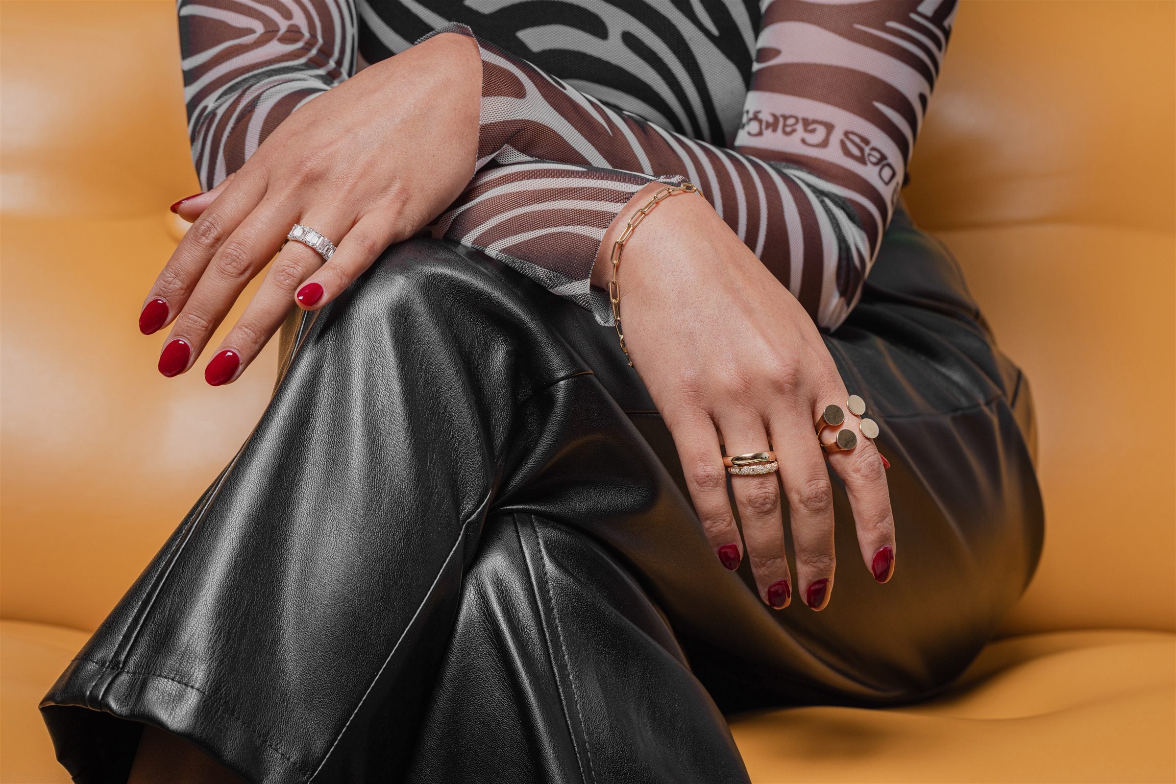 Atelier RMR diamond rings worn on an orange editorial set