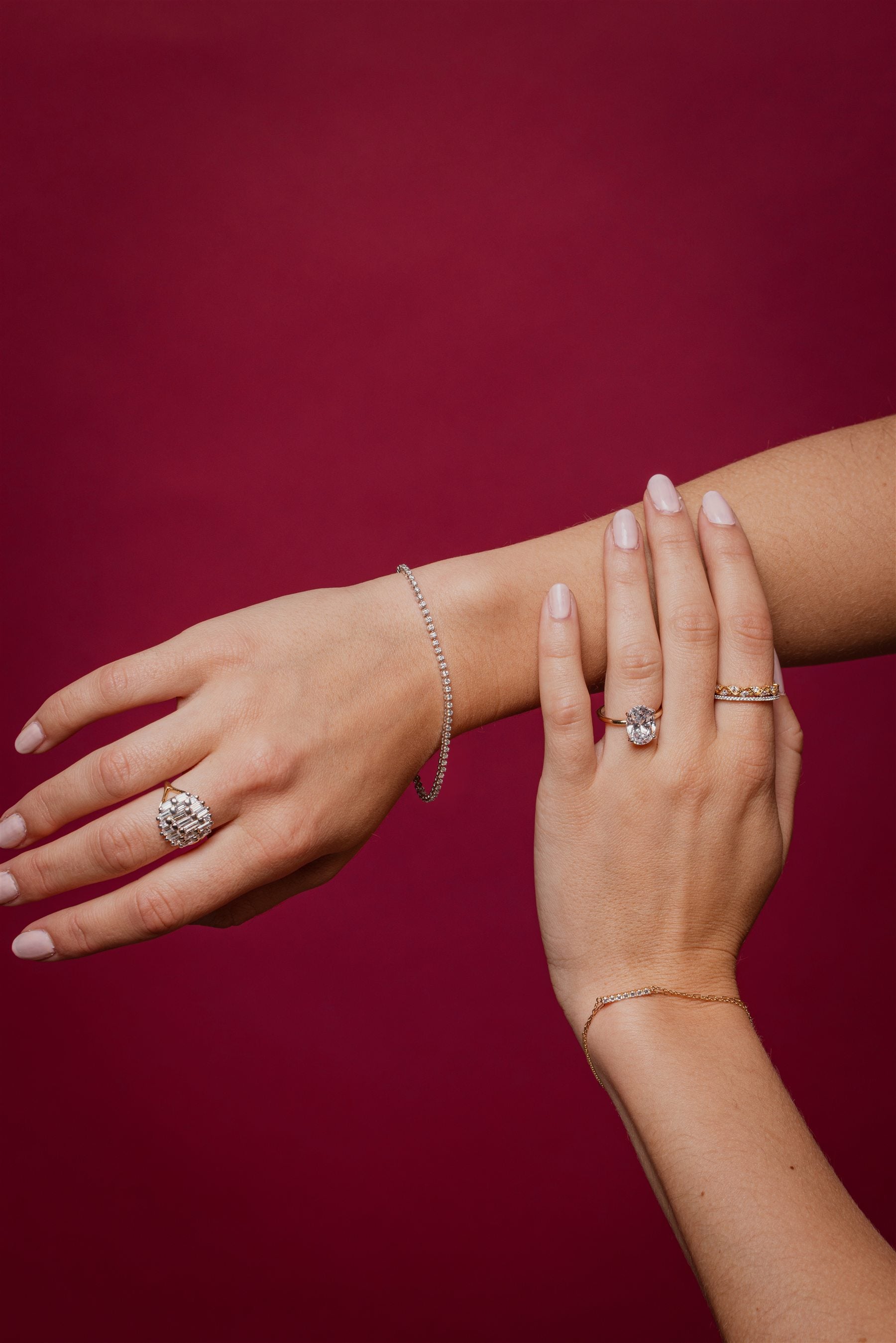 Atelier RMR diamond engagement ring and jewellery on a burgundy editorial set