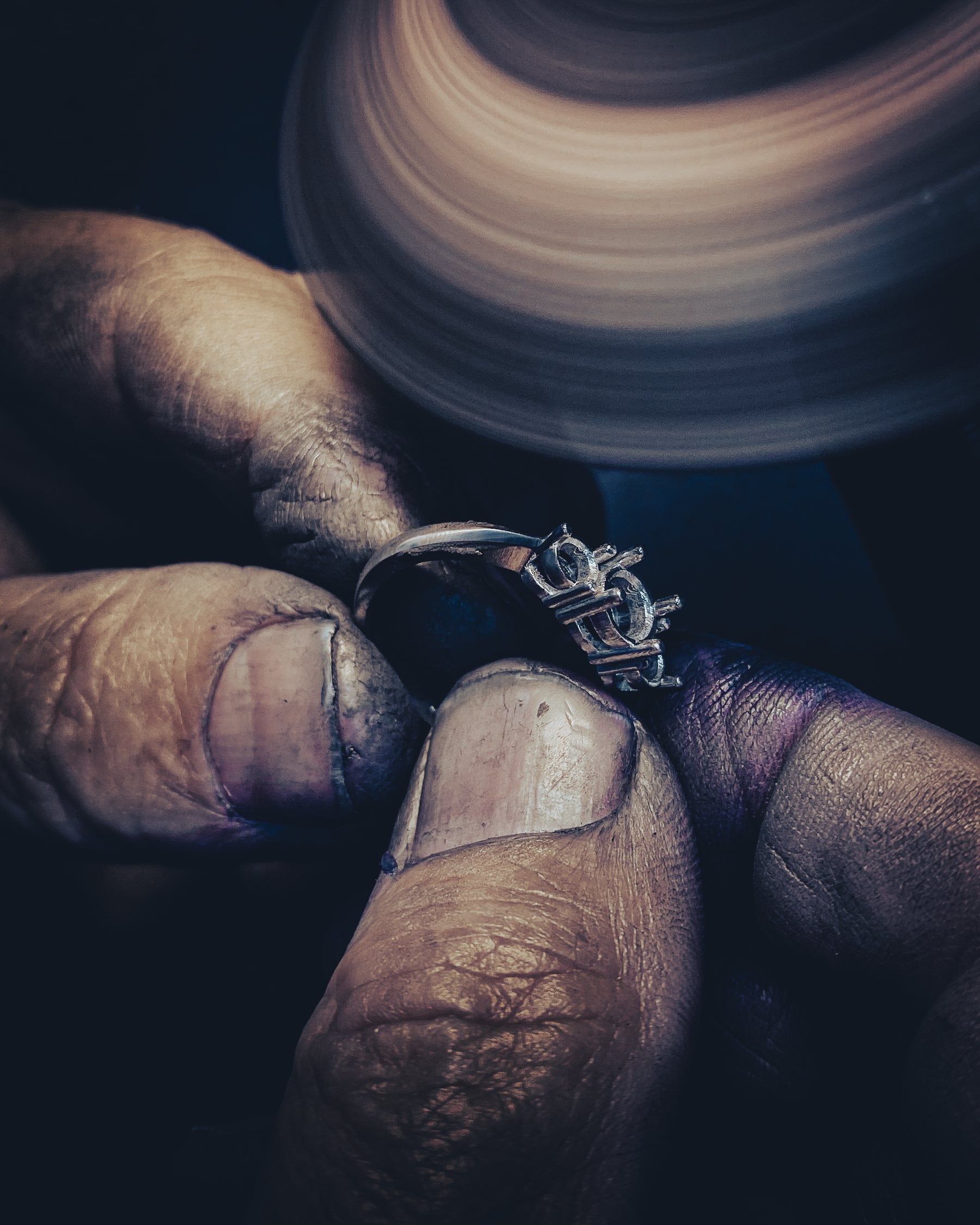 Jeweller polishing a ring setting during a jewelry repair